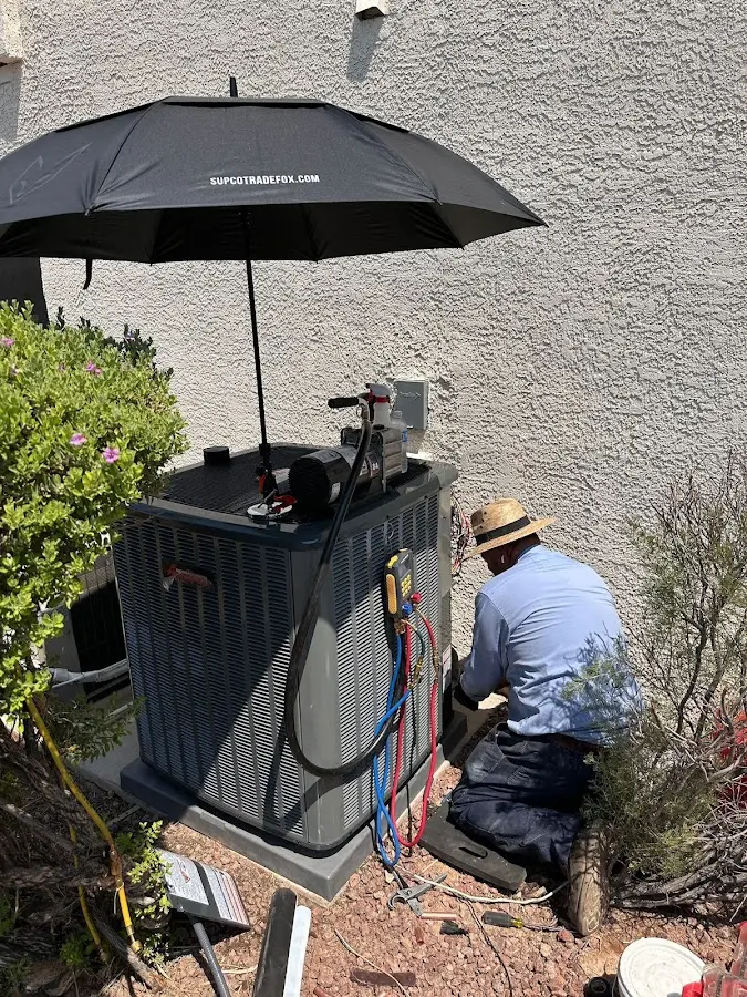 HVAC technician performing outdoor AC maintenance in Richmond Heights